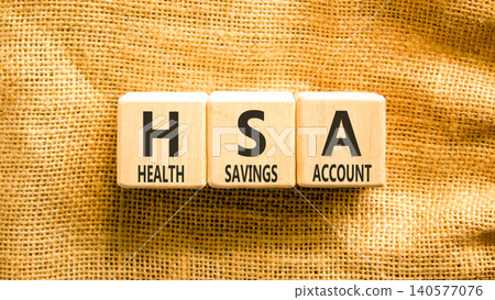 HSA health saving account symbol. Concept words HSA health saving account on beautiful wooden blocks. Beautiful canvas background. Medical HSA health saving account concept. Copy space. HSA health saving account symbol. Concept words HSA health saving account on beautiful wooden blocks. Beautiful canvas background. Medical HSA health saving account concept. Copy space. 140577076
