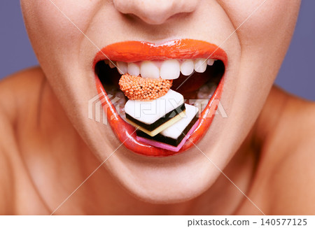Makeup, lipstick and woman with sweets in mouth, beauty and creativity with closeup of shiny cosmetic product. Licorice, candy and orange lip gloss for aesthetic, art and cosmetology with glamour Makeup, lipstick and woman with sweets in mouth, beauty and creativity with closeup of shiny cosmetic product. Licorice, candy and orange lip gloss for aesthetic, art and cosmetology with glamour 140577125