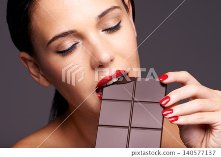 Beauty, makeup and woman with chocolate bar in studio for cosmetics, manicure and skincare in gray background. Sweets, closeup and face of model for cocoa product unhealthy snack or eating candy Beauty, makeup and woman with chocolate bar in studio for cosmetics, manicure and skincare in gray background. Sweets, closeup and face of model for cocoa product unhealthy snack or eating candy 140577137