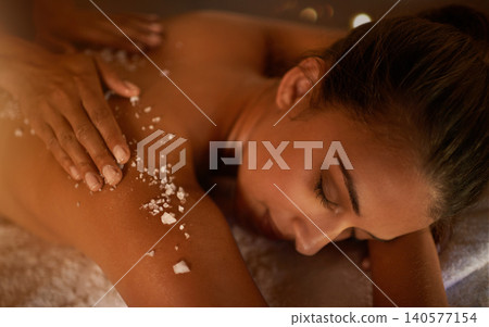 Hand, woman and salt at spa for massage, skin care and wellness for luxury, holistic therapy and peace. Scrub, exfoliate and health for lifestyle, body and person relax on table, calm and natural Hand, woman and salt at spa for massage, skin care and wellness for luxury, holistic therapy and peace. Scrub, exfoliate and health for lifestyle, body and person relax on table, calm and natural 140577154