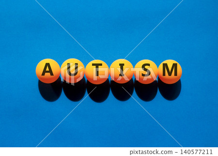 Autism medical symbol. Concept word Autism on beautiful orange table tennis ping pong balls. Beautiful blue background. Business autism medical concept. Copy space. Autism medical symbol. Concept word Autism on beautiful orange table tennis ping pong balls. Beautiful blue background. Business autism medical concept. Copy space. 140577211