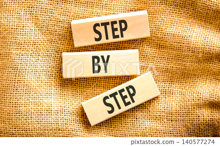 Next step words symbol. Concept words Step by step on beautiful wooden blocks. Beautiful canvas background. Business and next step concept. Copy space. Next step words symbol. Concept words Step by step on beautiful wooden blocks. Beautiful canvas background. Business and next step concept. Copy space. 140577274