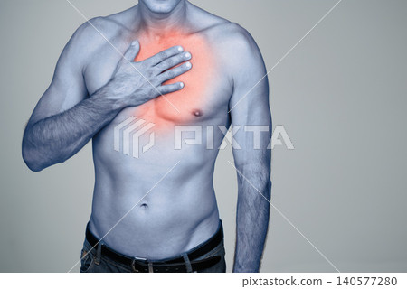 Hand, chest pain or man with heartburn in studio with inflammation, discomfort or injury space. Red glow, topless body or person with healthcare emergency, ache or strain by grey background mockup Hand, chest pain or man with heartburn in studio with inflammation, discomfort or injury space. Red glow, topless body or person with healthcare emergency, ache or strain by grey background mockup 140577280