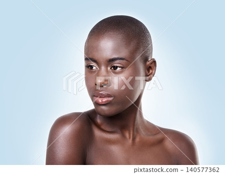 Face of black woman, natural skincare or thinking of beauty cosmetics or healthy skin in studio. Dermatology, wellness ideas or African girl model with glow or skincare results on blue background Face of black woman, natural skincare or thinking of beauty cosmetics or healthy skin in studio. Dermatology, wellness ideas or African girl model with glow or skincare results on blue background 140577362
