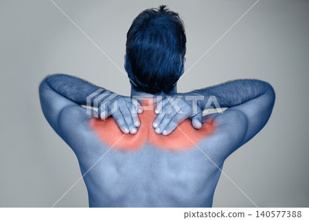 Studio, man and hands for shoulder pain or tension with muscle inflammation, discomfort and sprain of stress or strain. Red glow, back view and person with ache, injury and bruise on grey background Studio, man and hands for shoulder pain or tension with muscle inflammation, discomfort and sprain of stress or strain. Red glow, back view and person with ache, injury and bruise on grey background 140577388