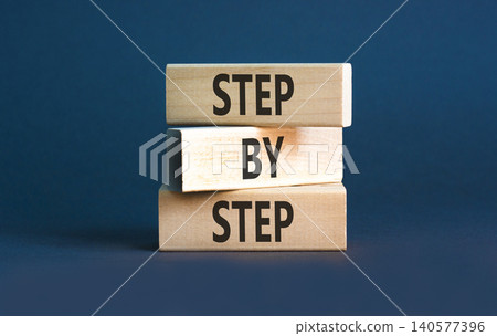 Next step words symbol. Concept words Step by step on beautiful wooden blocks. Beautiful grey background. Business and next step concept. Copy space. Next step words symbol. Concept words Step by step on beautiful wooden blocks. Beautiful grey background. Business and next step concept. Copy space. 140577396