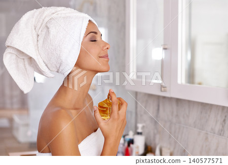 Spray, morning and woman in bathroom with perfume, towel and smile with luxury product. Getting ready, body care and girl with bottle in home, fragrance for clean and fresh smell, aroma or scent. Spray, morning and woman in bathroom with perfume, towel and smile with luxury product. Getting ready, body care and girl with bottle in home, fragrance for clean and fresh smell, aroma or scent. 140577571