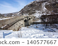 Historical Stone Bridge in Kars covered in snow framed by an old tree in winter, Turkey Historical Stone Bridge in Kars covered in snow framed by an old tree in winter, Turkey 140577667
