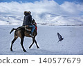 Horse rider and a bird flying over the frozen Lake Cildir in winter, Ardahan, Turkey Horse rider and a bird flying over the frozen Lake Cildir in winter, Ardahan, Turkey 140577679