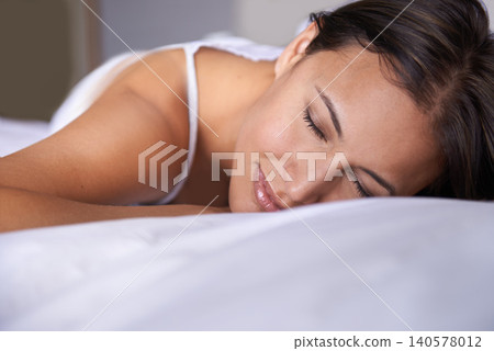 Woman, sleeping and fatigue in bed, relax at home for health and dream with wellness for peace and comfort. Cozy, calm and rest with nap in bedroom, asleep with eyes closed and tired with burnout Woman, sleeping and fatigue in bed, relax at home for health and dream with wellness for peace and comfort. Cozy, calm and rest with nap in bedroom, asleep with eyes closed and tired with burnout 140578012