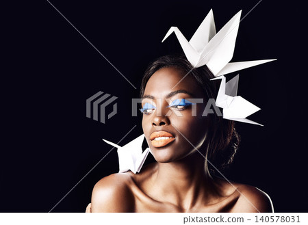 Studio, makeup and natural cosmetics for black woman in dark background with aesthetic for honor. Eyeshadow, glow and foundation on face of girl for shine, African female person and origami birds Studio, makeup and natural cosmetics for black woman in dark background with aesthetic for honor. Eyeshadow, glow and foundation on face of girl for shine, African female person and origami birds 140578031