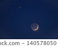 Crescent moon and bright venus planet in the dark blue night sky Crescent moon and bright venus planet in the dark blue night sky 140578050