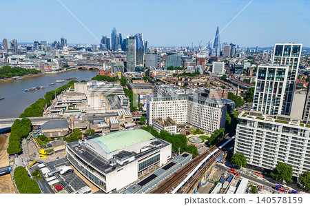 Drone point of  view on downtown of London :   The London Eye, Westminster Abbey in the background and the River Thames on a sunny summer day 140578159