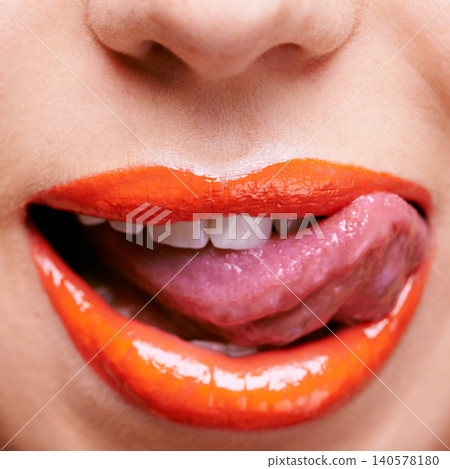 Beauty, lipstick and mouth of woman with tongue out, makeup and closeup of shiny cosmetic product with skin. Lick, flirting and orange lip gloss for aesthetic with cosmetology, glow and bold color Beauty, lipstick and mouth of woman with tongue out, makeup and closeup of shiny cosmetic product with skin. Lick, flirting and orange lip gloss for aesthetic with cosmetology, glow and bold color 140578180