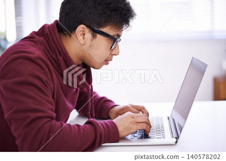 Young man, focus and typing with laptop for research, development or creative startup on table at office desk. Male person, nerd or geek with vision on computer for email, networking or communication Young man, focus and typing with laptop for research, development or creative startup on table at office desk. Male person, nerd or geek with vision on computer for email, networking or communication 140578202