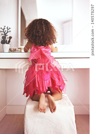 Girl, back and mirror with dress for costume, stylish outfit or creativity with cosmetics or fashion. Princess, child and female kid ready for fantasy with makeup or reflection in the home or house Girl, back and mirror with dress for costume, stylish outfit or creativity with cosmetics or fashion. Princess, child and female kid ready for fantasy with makeup or reflection in the home or house 140578297