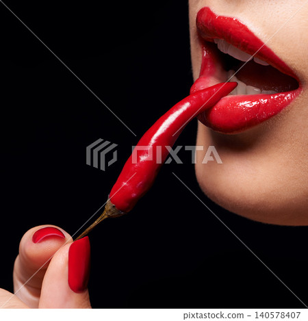 Chili, red lipstick and closeup of woman lips in studio with trendy, beauty and manicure treatment. Mouth, cosmetics and female person with nail polish eat pepper for cosmetology by black background. 140578407