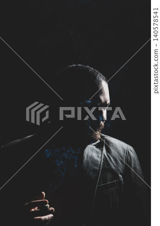Man Smoking Cigar in Cinematic Studio Lighting. Man Smoking Cigar in Cinematic Studio Lighting. 140578541
