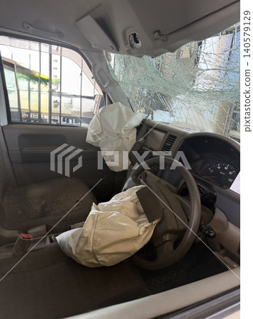 The driver's seat of the crashed car where the airbag deployed. 140579129