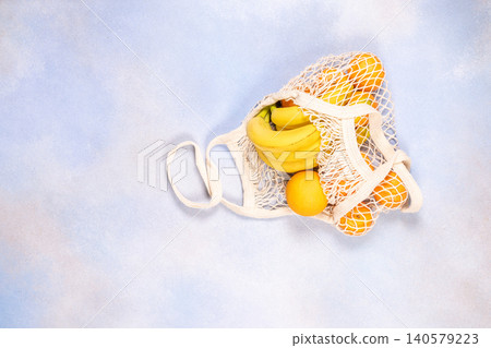 Reusable mesh bag holding zero waste fresh fruit 140579223