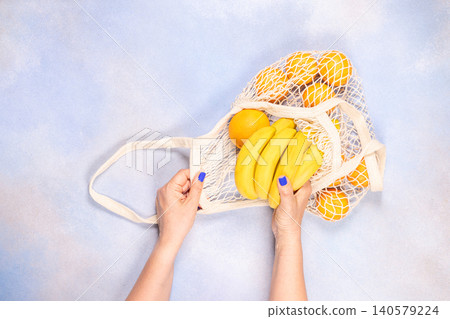 Woman's hands using mesh bag for zero waste shopping Woman's hands using mesh bag for zero waste shopping 140579224
