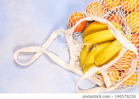 Reusable mesh produces bag with bananas and citrus fruit Reusable mesh produces bag with bananas and citrus fruit 140579226