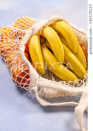 Reusable mesh bag filled with fresh fruits Reusable mesh bag filled with fresh fruits 140579227