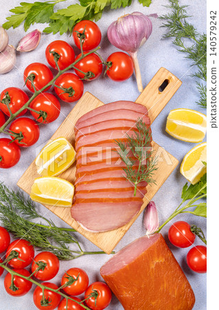 Sliced smoked meat appetizer with fresh ingredients on board 140579242