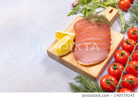 Sliced smoked pork loin with fresh tomatoes and lemon Sliced smoked pork loin with fresh tomatoes and lemon 140579245