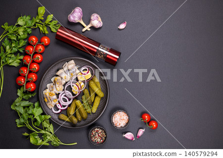 Pickled herring fillet slices with onion on plate Pickled herring fillet slices with onion on plate 140579294