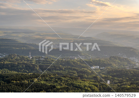 Layers of green mountains and hills in the haze during sunset. Panoramic View of Green hills and Meadow. Layers of green mountains and hills in the haze during sunset. Panoramic View of Green hills and Meadow. 140579529