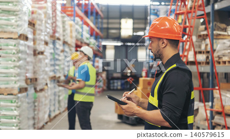 Warehouse management logistics team counting checking products on inventory shelf. Hispanic men worker check stock control in distribution storage. Teamwork shipment worker checklist quality control Warehouse management logistics team counting checking products on inventory shelf. Hispanic men worker check stock control in distribution storage. Teamwork shipment worker checklist quality control 140579615