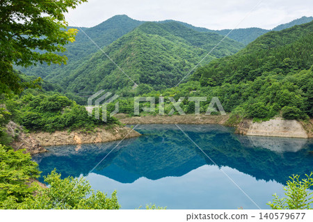 A windless day at Okushima Lake; the scenery reflected like a mirror on the lake's surface. Nakanojo Town, Gunma Prefecture. A windless day at Okushima Lake; the scenery reflected like a mirror on the lake's surface. Nakanojo Town, Gunma Prefecture. 140579677