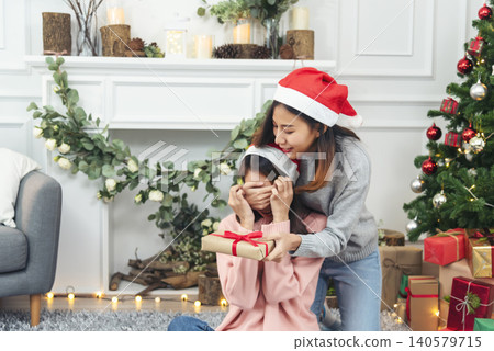 Two Women siblings using hands decorate Christmas tree red ball, bauble, snow flake. Close up hands holding red ball bauble decorate. Asian woman friends decor bauble ball christmas tree xmas holiday Two Women siblings using hands decorate Christmas tree red ball, bauble, snow flake. Close up hands holding red ball bauble decorate. Asian woman friends decor bauble ball christmas tree xmas holiday 140579715