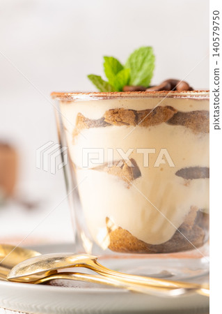 Classic Tiramisu in Glass Cup with Gold Spoons Classic Tiramisu in Glass Cup with Gold Spoons 140579750