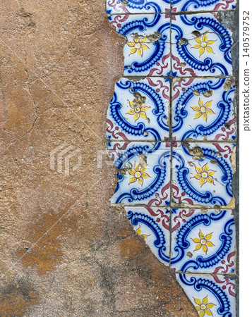 Historic blue azulejos on weathered plaster wall 140579752