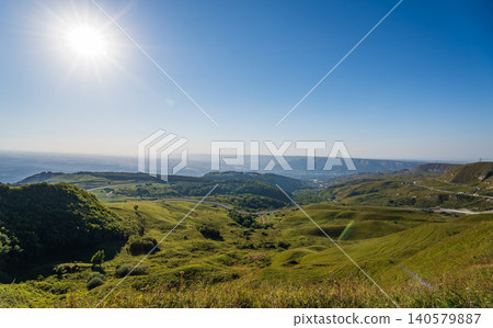 Layers of green mountains and hills in the haze during sunset. Panoramic View of Green hills and Meadow. Layers of green mountains and hills in the haze during sunset. Panoramic View of Green hills and Meadow. 140579887