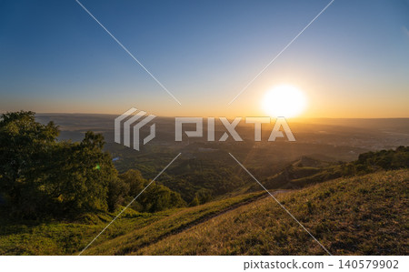 View of the mountains and Kislovodsk from the observation decks of the Kislovodsk Park. Evening sunset over the mountains of Kislovodsk. 140579902