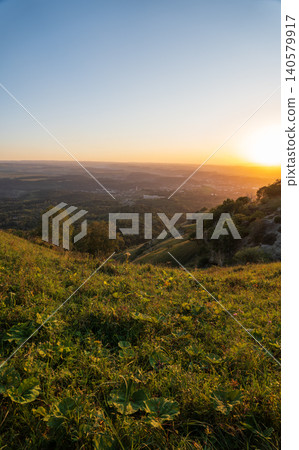 View of the mountains and Kislovodsk from the observation decks of the Kislovodsk Park. Evening sunset over the mountains of Kislovodsk. View of the mountains and Kislovodsk from the observation decks of the Kislovodsk Park. Evening sunset over the mountains of Kislovodsk. 140579917