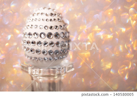Decorative egg adorned with rhinestones displayed on a glass pedestal against a shimmering pastel background, ideal for Easter or festive celebrations Decorative egg adorned with rhinestones displayed on a glass pedestal against a shimmering pastel background, ideal for Easter or festive celebrations 140580005