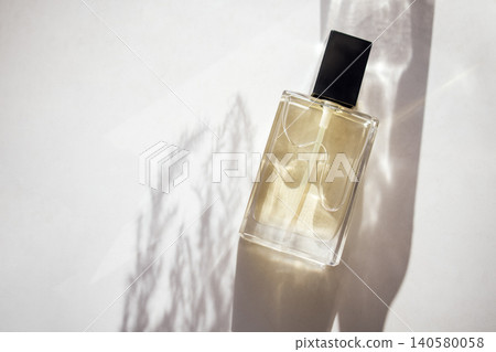 Elegant perfume bottle with a sleek design, casting soft shadows on a light background, showcasing luxury and sophistication in fragrance presentation Elegant perfume bottle with a sleek design, casting soft shadows on a light background, showcasing luxury and sophistication in fragrance presentation 140580058