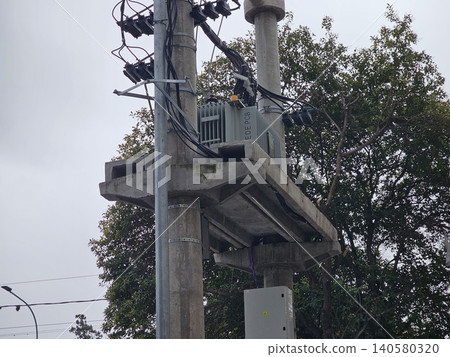 Electrical utility infrastructure with overhead cables in urban setting Electrical utility infrastructure with overhead cables in urban setting 140580320