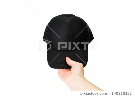 hand holds a black baseball cap straight in front of itself on an isolated white background hand holds a black baseball cap straight in front of itself on an isolated white background 140580332