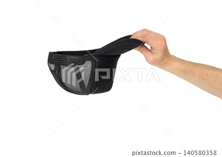 human hand holding black baseball cap from side human hand holding black baseball cap from side 140580358
