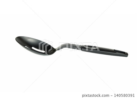 kitchen plastic black spoon with a narrow hole in the bowl lies at an angle on a light background kitchen plastic black spoon with a narrow hole in the bowl lies at an angle on a light background 140580391