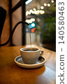Warm Cafe Coffee Pouring Into White Ceramic Cup on Wooden Table 140580463