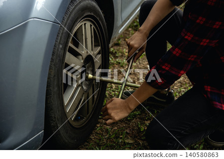 Young women try to change tyre self service. Car problem breakdown. Woman calling mechanic car service technician support fix repair driving. Transportation vehicle accident emergency problem Young women try to change tyre self service. Car problem breakdown. Woman calling mechanic car service technician support fix repair driving. Transportation vehicle accident emergency problem 140580863