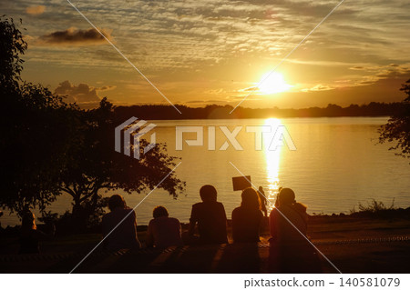 Silhouette of people watching a beautiful sunset over Lake Guaiba in Porto Alegre, RS, Brazil Silhouette of people watching a beautiful sunset over Lake Guaiba in Porto Alegre, RS, Brazil 140581079