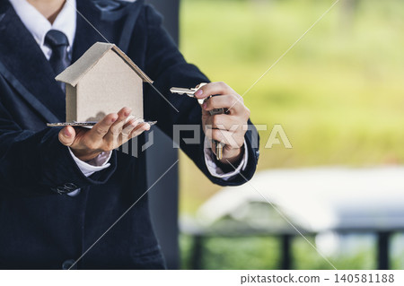 Real estate agent hands holding home business mortgage loan investment property. Hands saving protection home residential concepts. Insurance Agent sale residence ownership household protection care Real estate agent hands holding home business mortgage loan investment property. Hands saving protection home residential concepts. Insurance Agent sale residence ownership household protection care 140581188