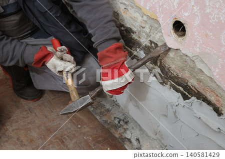 Adult worker demolish old house 140581429